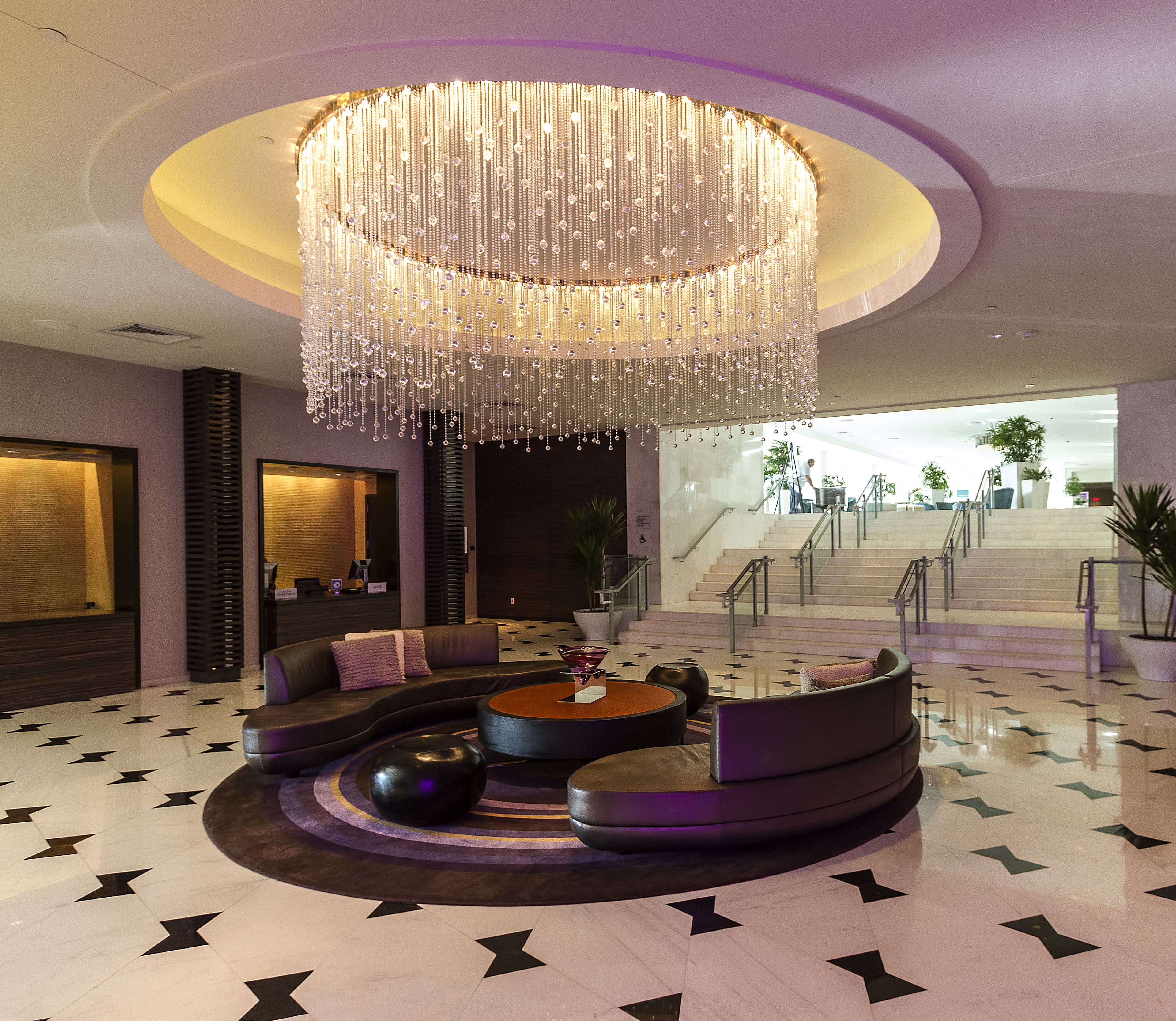 Fountainebleau Hotel in Miami Florida lobby and entrance. There is a large crystal chandelier and seating