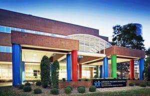 Arnold Palmer Hospital for Children entrance. There are blue, green, and red pillars.