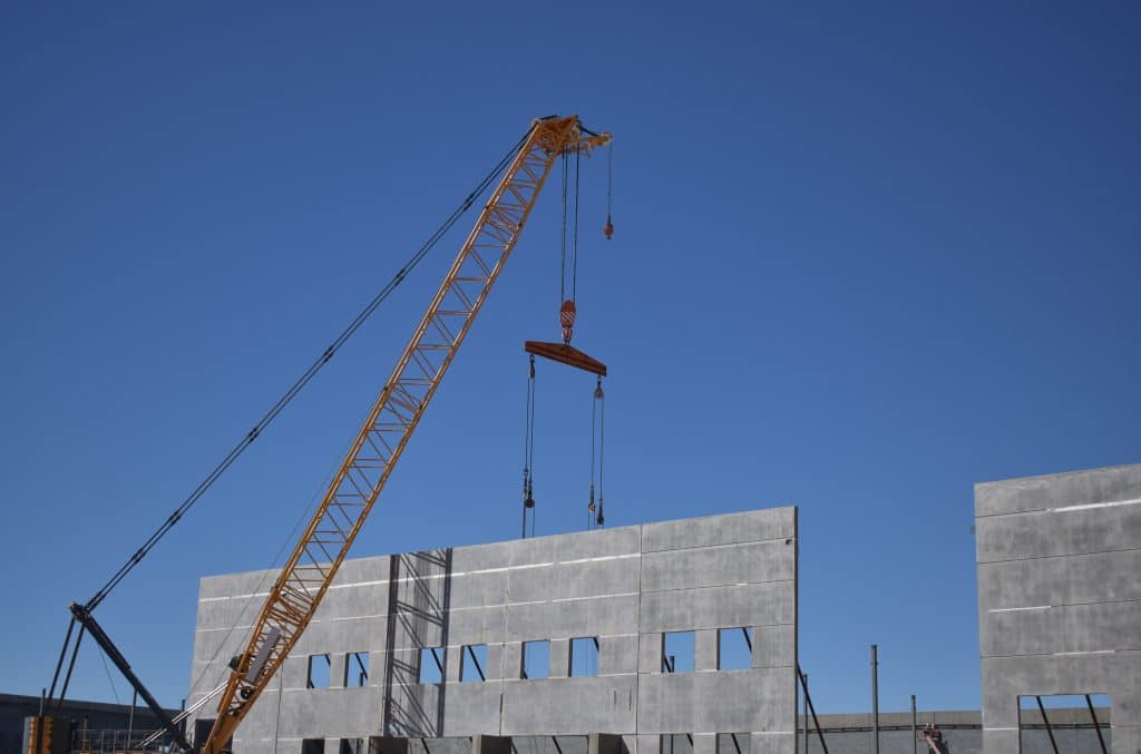 Construction site putting up a big wall with a crane